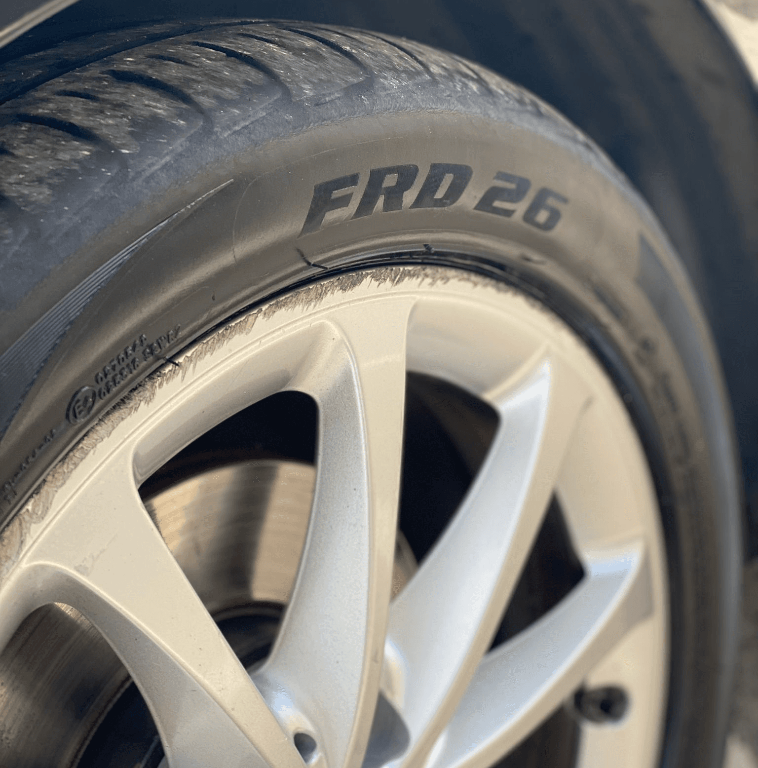 An image of a scratched alloy wheel