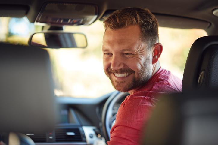 Man smiling in car